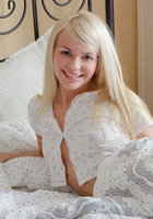 Милая блондинка снимает пижаму не поднимаясь с постели 2 фото