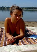 Сексуальная молодуха загорает на пляже топлесс 19 фото