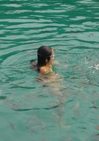 Азиатка стоит возле моря без купальника 3 фото