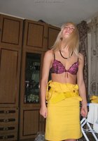 Блондинка снимает с себя белье возле гладильной доски 1 фото