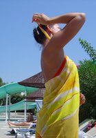 Взрослая брюнетка отдыхает в бассейне топлес 7 фотография
