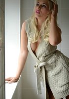 Блондинка снимает платье на фоне белого кафеля 1 фотография
