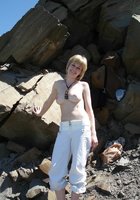 Развратная блондинка Алена загорает на скалистом берегу 2 фото