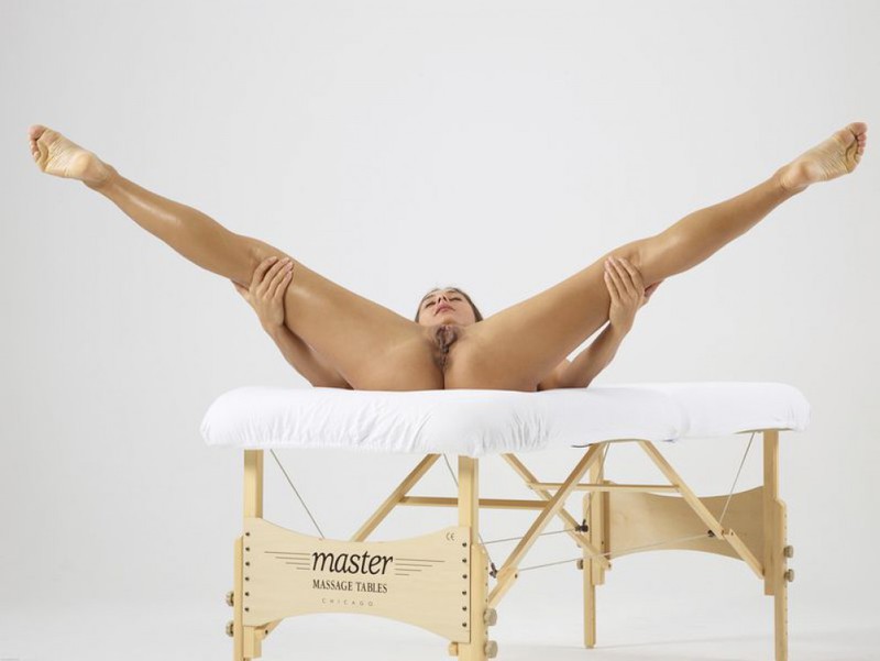 Доминика широко расставляет ноги лежа на массажном столе 29 фотография
