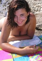 Нудистка с большими дойками отдыхает на пляже 4 фото