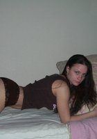 Карина в позирует на кровати в коричневых трусах и футболке 11 фото