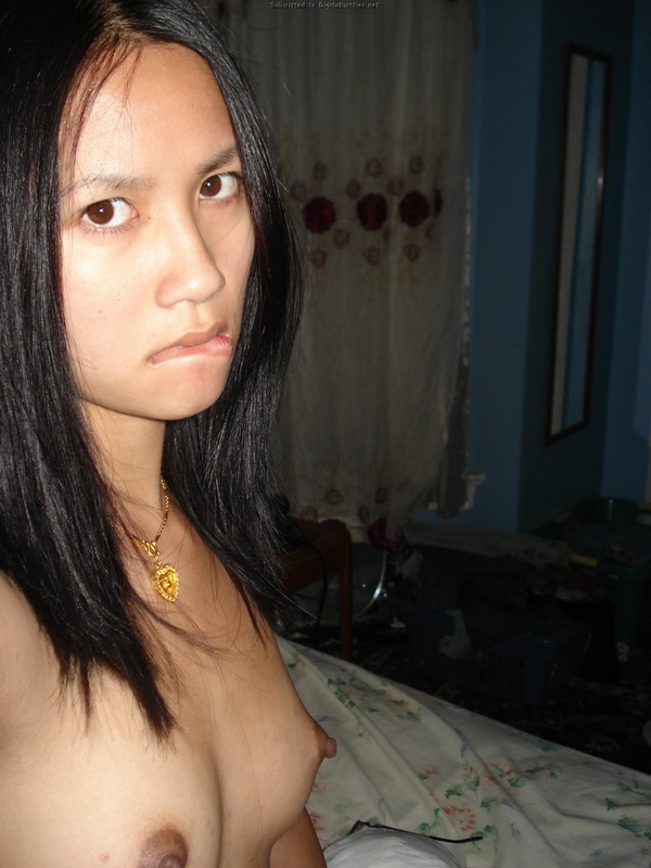 Молоденькая азиатка светит киской в комнате с выключенным светом 10 фотография