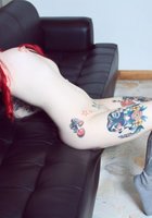 Красноволосая Сара ваяется на черном диване без белья 32 фотография