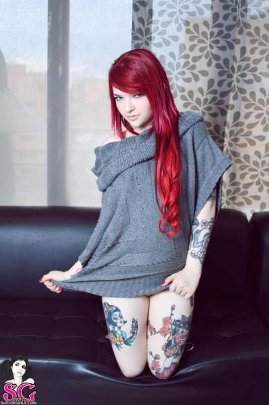 Красноволосая Сара ваяется на черном диване без белья 18 фотография