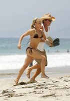 Девушки в купальниках бегают по пляжу 6 фото