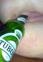 Вертихвостка трахает свою манду пустой бутылкой пива 14 фотография