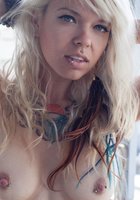 Татуированная блонда оголила стройное тело на веранде 18 фотография