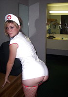 Медсестра в коротком халатике позирует у себя в квартире 16 фотография
