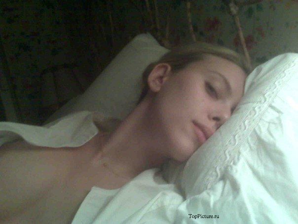 Голая девушка снимает себя на камеру телефона лежа на кровати 2 фотография