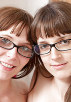 Молодые лесбиянки в очках занимаются взаимной мастурбацией на кровати 16 фото